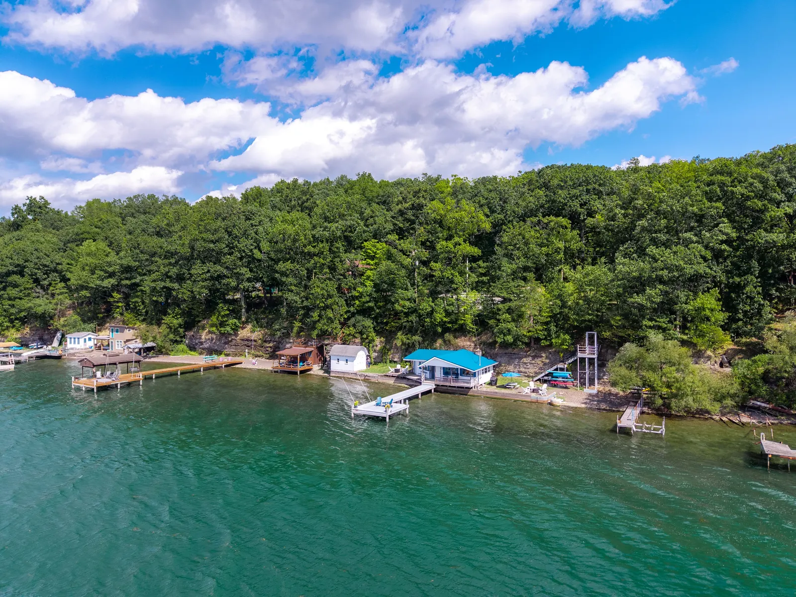 Smooth Sailing FLX — wide compound view showing cottage among east-shore neighbors